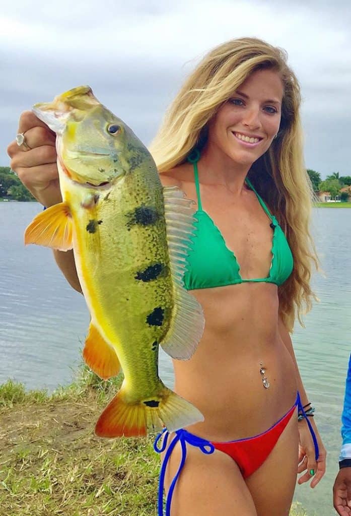 woman holding peacock bass