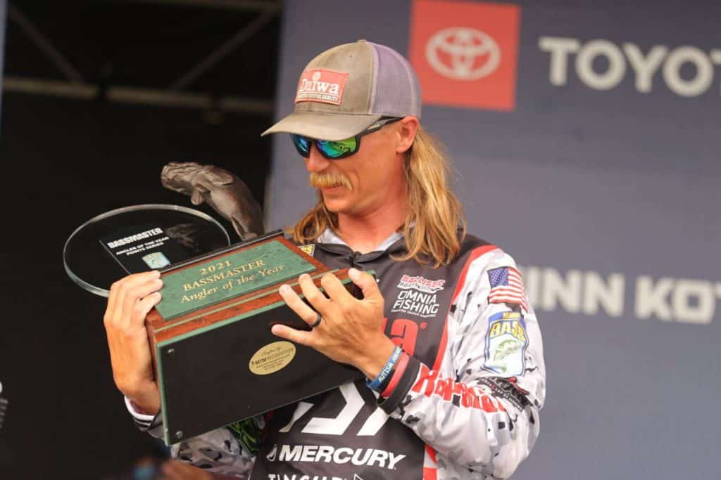seth feider holding 2021 bassmaster angler of the year trophy