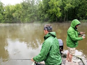 2 anglers with rain gear on bass fishing in the rain