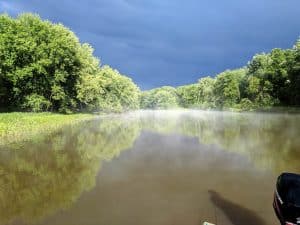 landscape image of upper Mississippi river backwater. bass fishing in the rain before during and after a storm