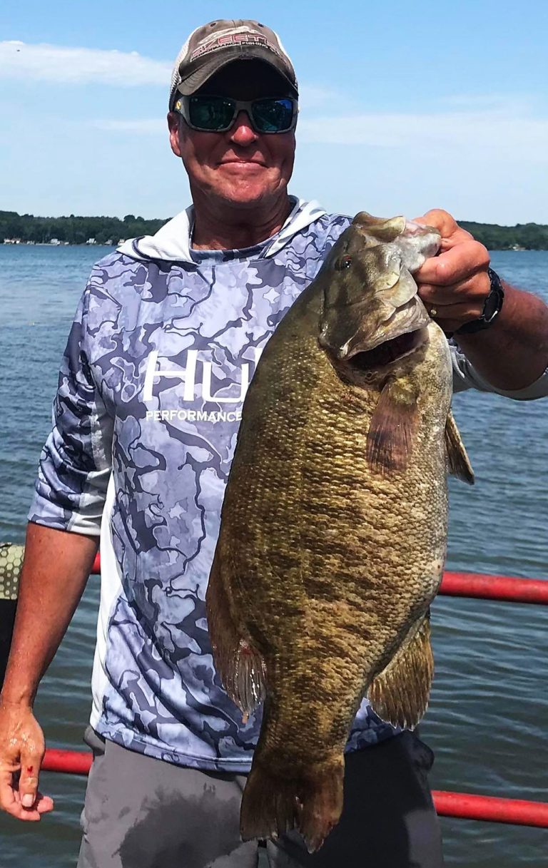man lands state record smallmouth bass in New York on Cayuga Lake