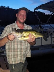 night fishing for bass with man holding a 4.7 pound largemouth