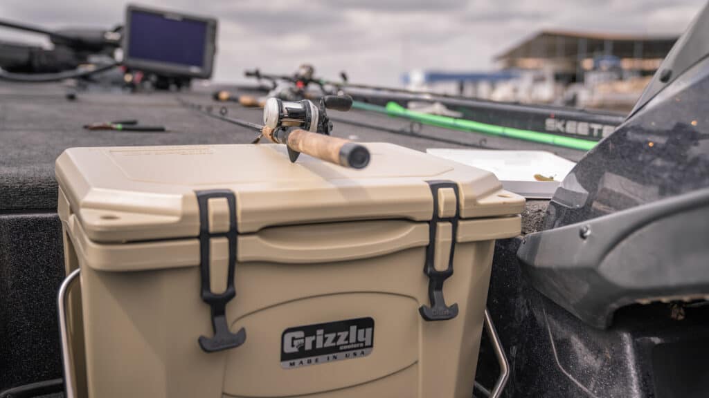tan grizzly cooler with baitcaster rod and reel resting ontop of it