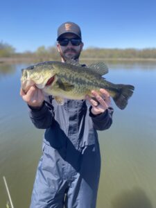 Mike Salerno holding a recently caught spotted largemouth bass