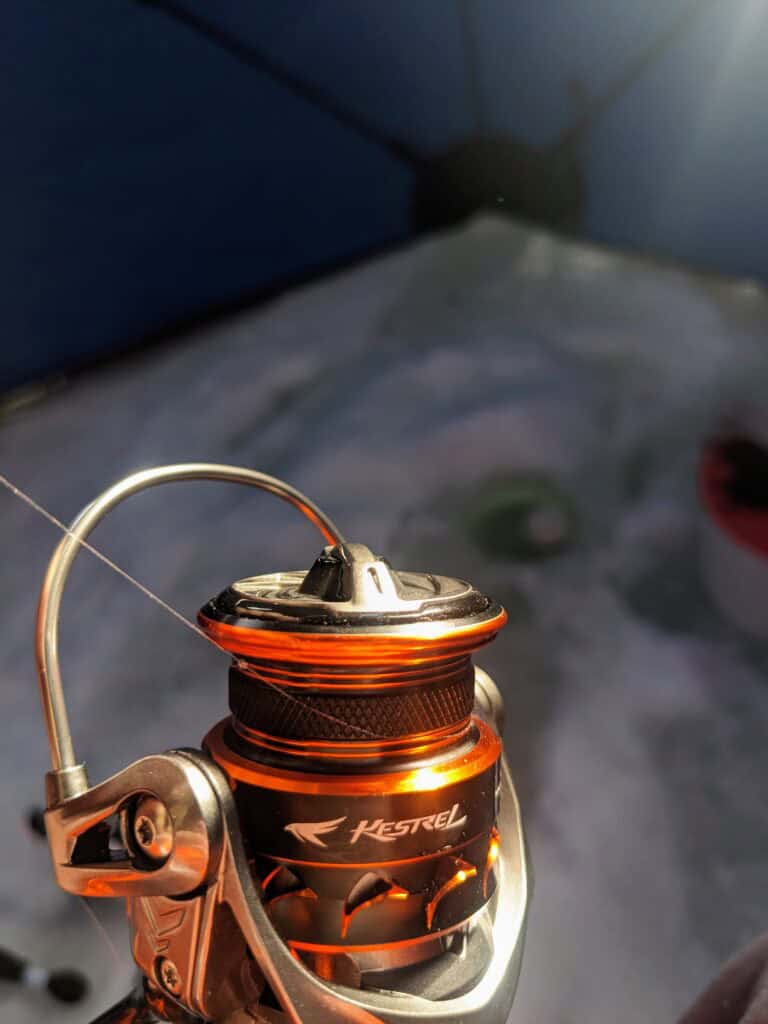 kastking kestrel spinning reel with empty spool in ice shack